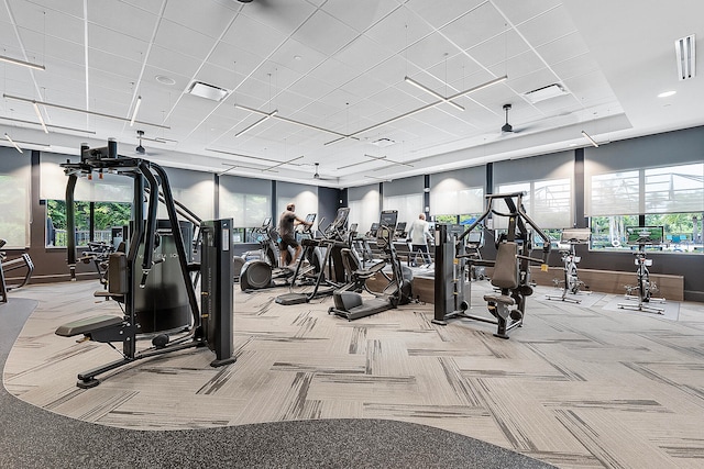 gym featuring ceiling fan and light colored carpet