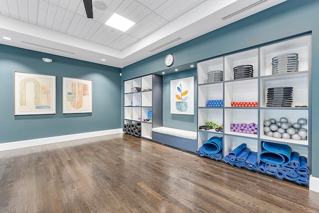 exercise room featuring wood-type flooring and ceiling fan