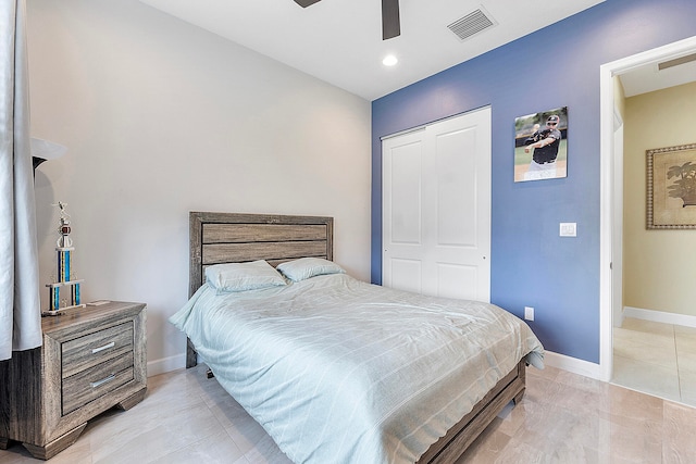 bedroom featuring a closet, ceiling fan, and light tile patterned floors