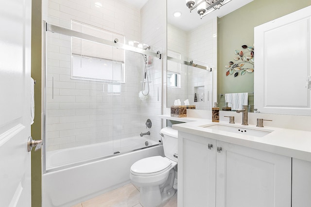 full bathroom with vanity, bath / shower combo with glass door, toilet, and tile patterned floors