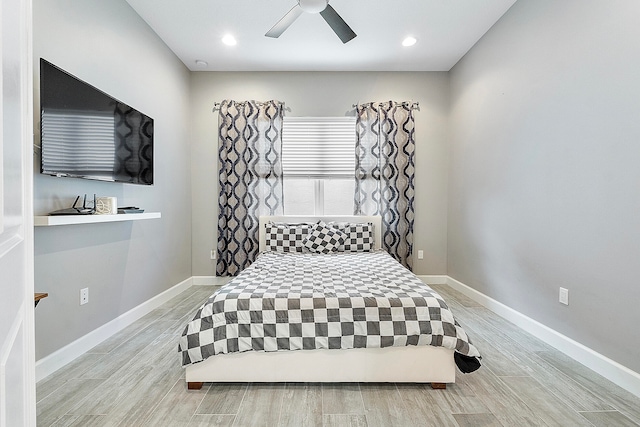 bedroom with ceiling fan and light hardwood / wood-style floors