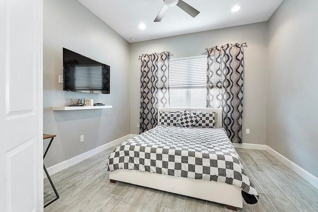 bedroom with ceiling fan and light hardwood / wood-style floors