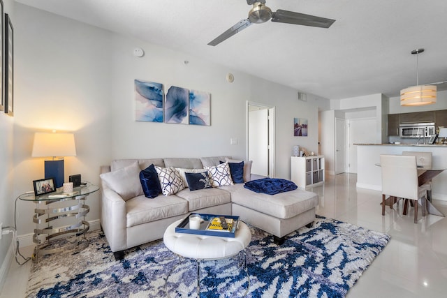 living room with ceiling fan and light tile patterned flooring