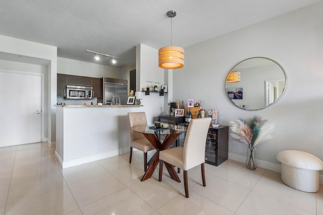 tiled dining room with a textured ceiling