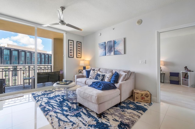 tiled living room with a textured ceiling and ceiling fan