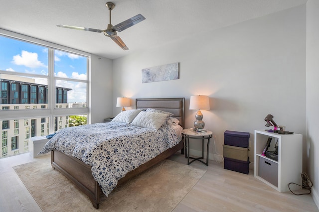 bedroom featuring light wood-type flooring and ceiling fan