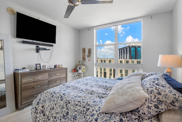 bedroom with light hardwood / wood-style flooring and ceiling fan