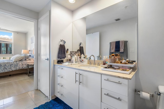 bathroom featuring vanity, toilet, and tile patterned floors