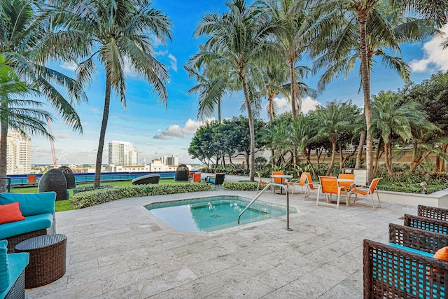 view of swimming pool featuring an in ground hot tub and a patio