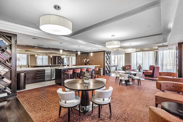 dining area with wine cooler and a tray ceiling