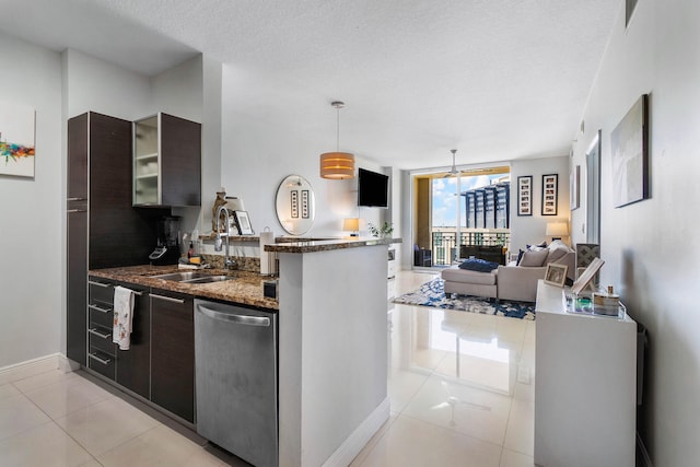 kitchen featuring stainless steel dishwasher, pendant lighting, light tile patterned flooring, and a textured ceiling