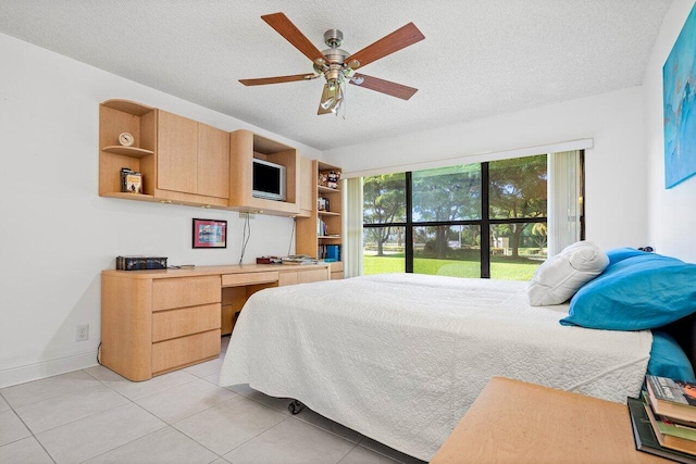 bedroom with built in desk, light tile patterned flooring, a textured ceiling, and ceiling fan