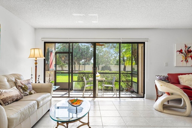 living room with a textured ceiling, light tile patterned flooring, and plenty of natural light