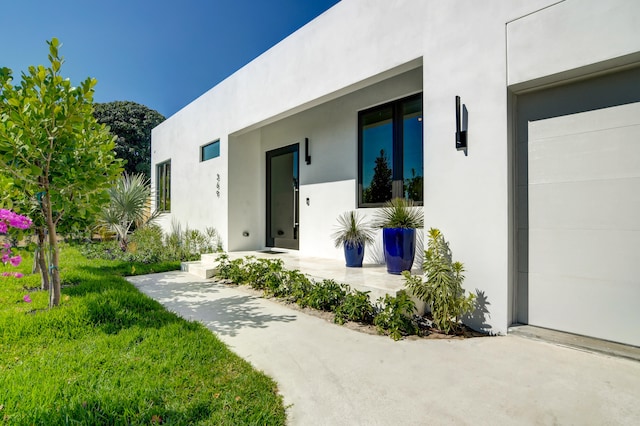 doorway to property featuring a lawn