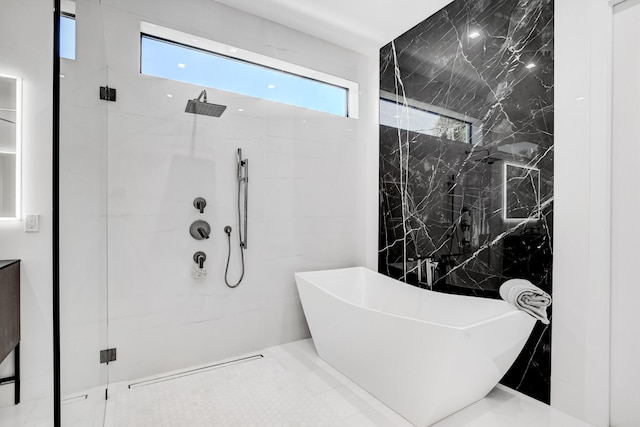 bathroom with vanity, tile walls, and plus walk in shower