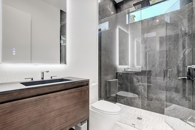 bathroom with toilet, an enclosed shower, and vanity