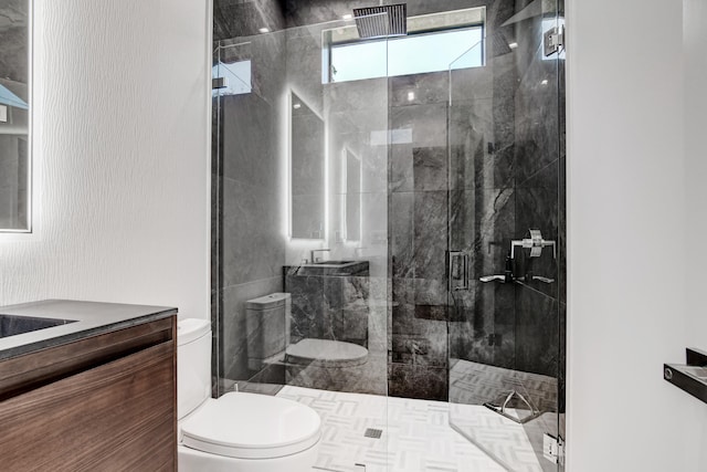 bathroom with toilet, a shower with shower door, and vanity