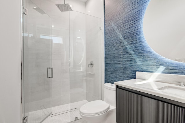 bathroom featuring toilet, an enclosed shower, vanity, and tile walls