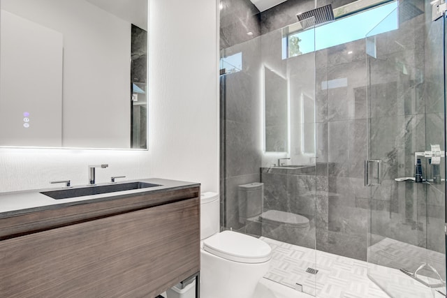 bathroom featuring vanity, toilet, and walk in shower