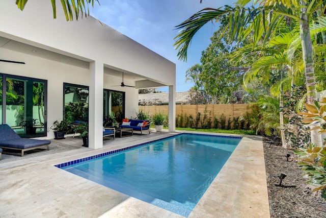 view of pool with a patio, outdoor lounge area, and ceiling fan