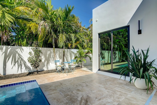 view of patio / terrace with a fenced in pool