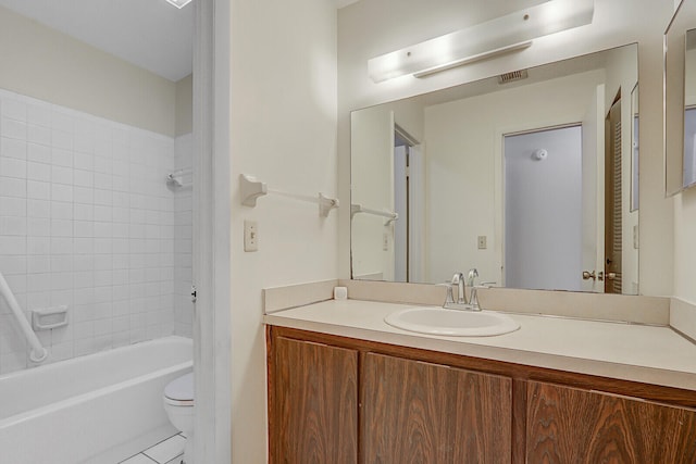 full bathroom with tile patterned flooring, vanity, toilet, and tiled shower / bath combo