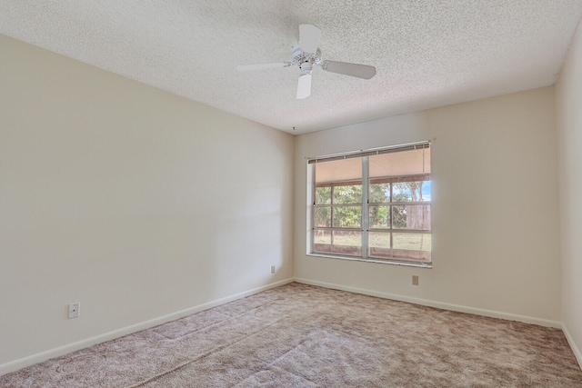 carpeted empty room featuring a textured ceiling and ceiling fan