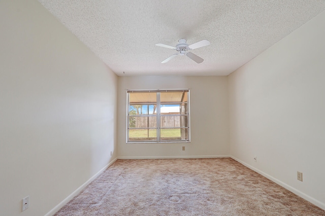 carpeted empty room featuring ceiling fan and a textured ceiling