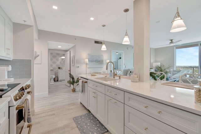 kitchen featuring light hardwood / wood-style floors, electric range, high end white fridge, and white cabinetry