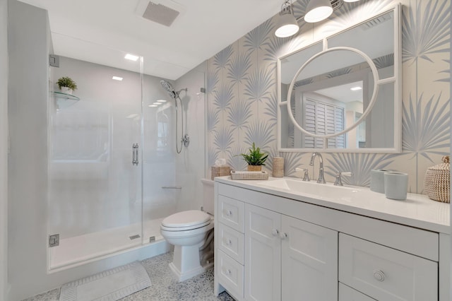 bathroom featuring walk in shower, vanity, and toilet