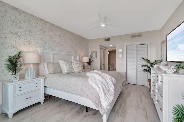 bedroom with ceiling fan, light hardwood / wood-style floors, and a closet