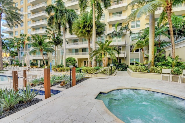 view of swimming pool with a community hot tub