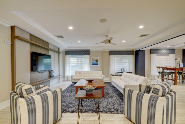 living room with ceiling fan, crown molding, and a raised ceiling