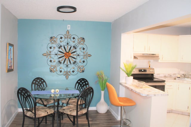 dining room featuring light wood-style flooring and baseboards