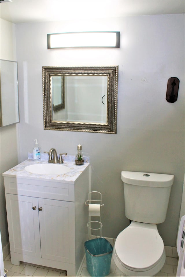 bathroom with vanity, toilet, and tile patterned floors