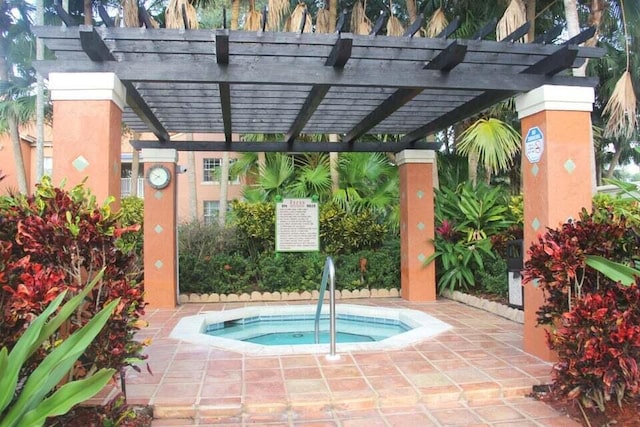 view of pool with a hot tub and a pergola