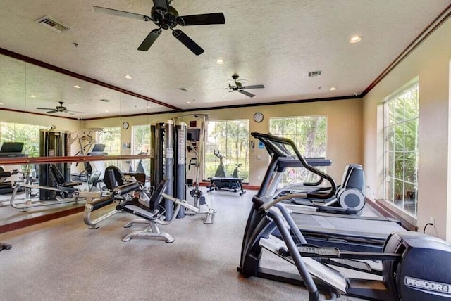 gym with ornamental molding, a textured ceiling, and ceiling fan