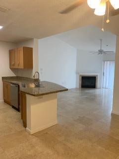 kitchen featuring sink, dishwasher, kitchen peninsula, and ceiling fan