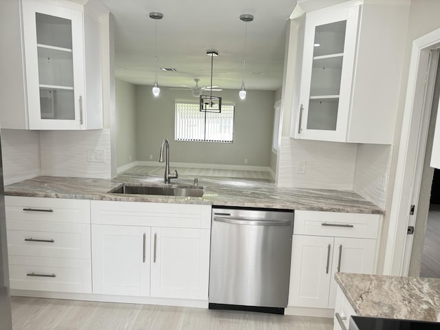 kitchen featuring dishwasher, sink, and white cabinets