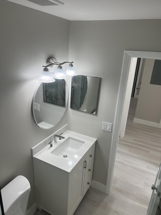 14910 Wildflower Ln, Delray Beach, FL 33446 - bathroom featuring vanity, toilet, baseboards, and wood finished floors