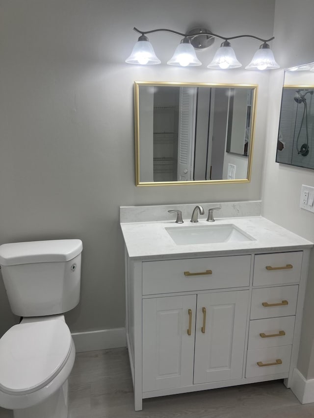 14910 Wildflower Ln, Delray Beach, FL 33446 - bathroom featuring toilet, vanity, and baseboards