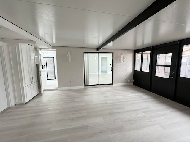 interior space with vaulted ceiling with beams and light wood-type flooring