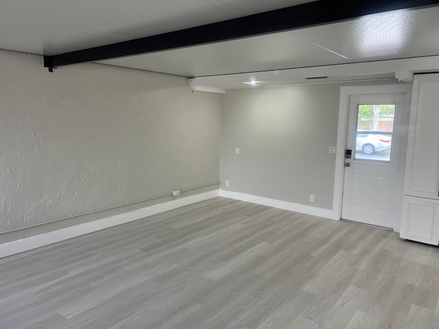 basement with light hardwood / wood-style flooring