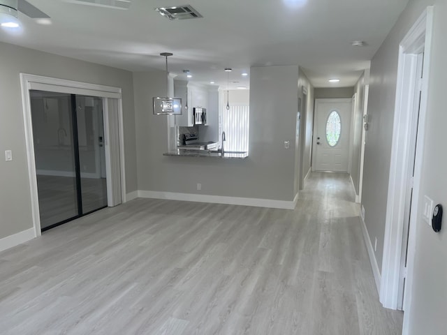 unfurnished living room featuring light hardwood / wood-style flooring