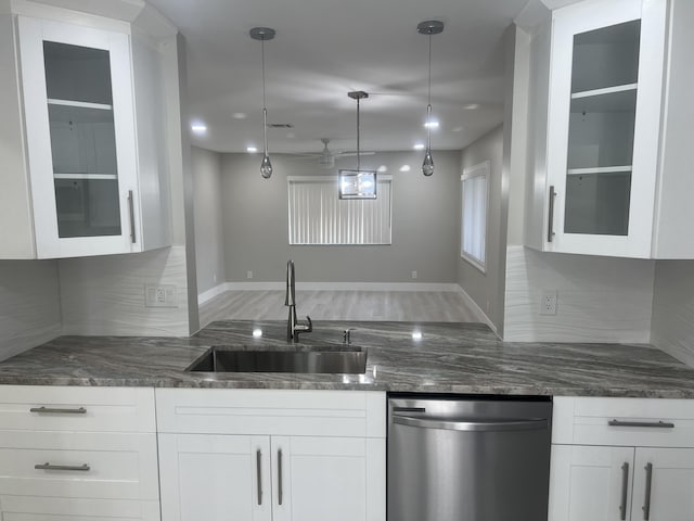 14910 Wildflower Ln, Delray Beach, FL 33446 - kitchen with dishwasher, a sink, glass insert cabinets, and dark stone counters