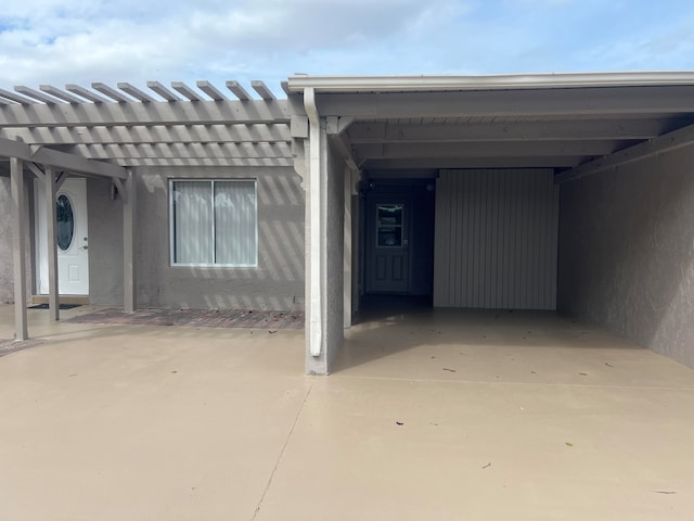 view of exterior entry with a carport