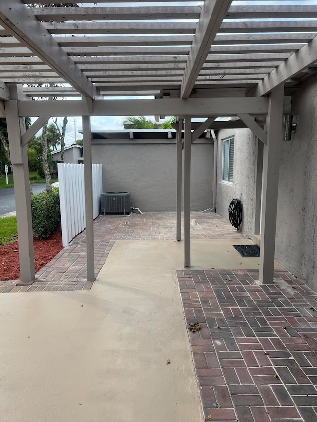 view of patio featuring a pergola and central AC