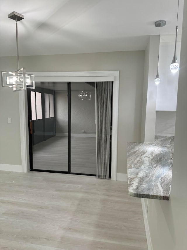 unfurnished dining area with light hardwood / wood-style flooring