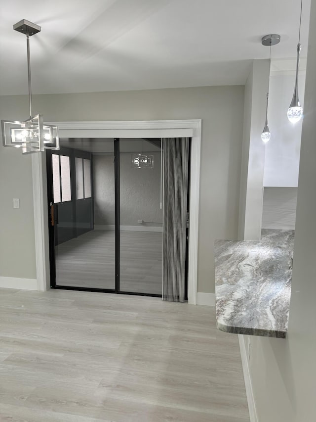 14910 Wildflower Ln, Delray Beach, FL 33446 - spare room with wood finished floors, baseboards, and a chandelier