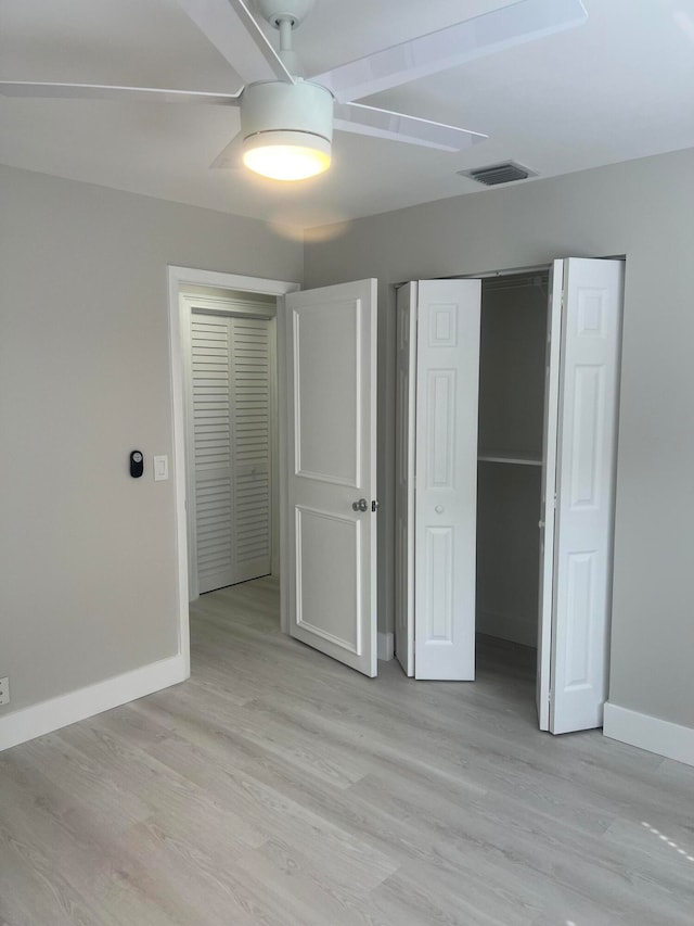 unfurnished bedroom featuring light hardwood / wood-style floors and ceiling fan